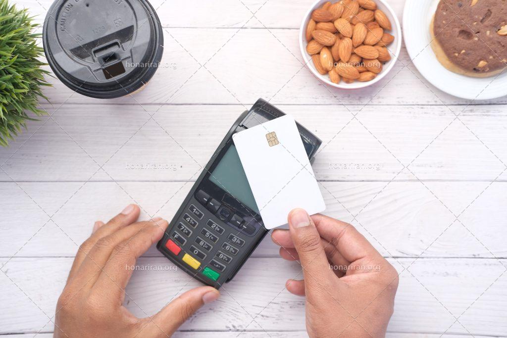 عکس با کیفیت کارتخوان و کارت عابر در دست مرد