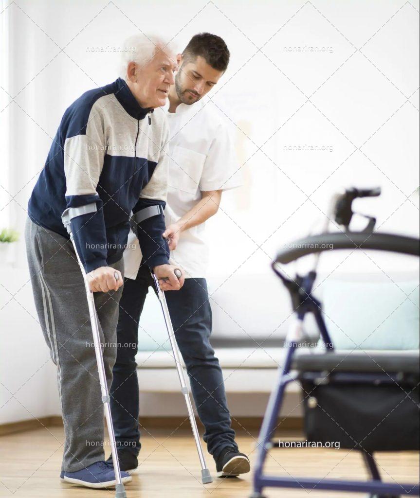 عکس با کیفیت پیرمرد در حال راه رفتن با عصا